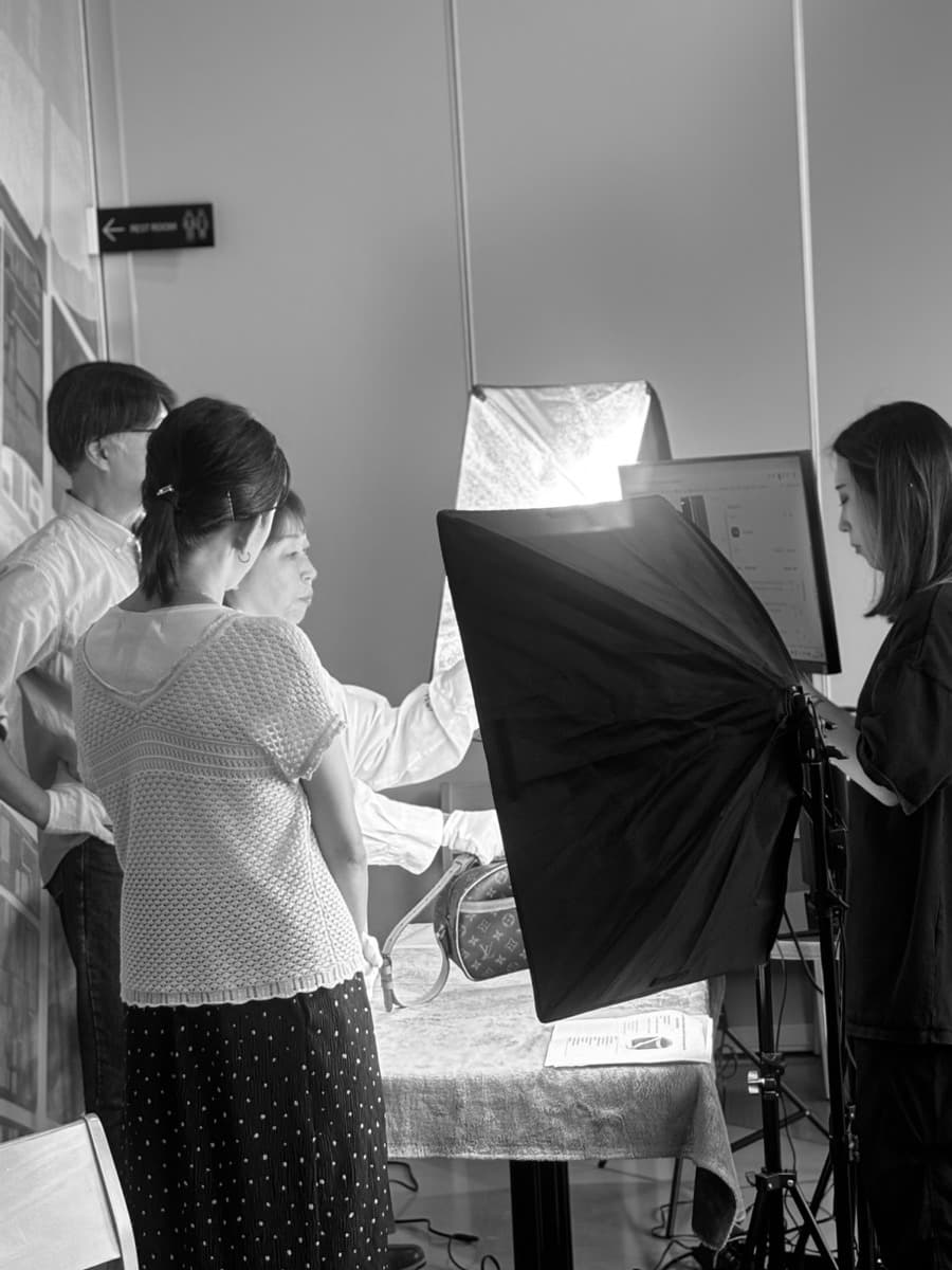 Staff inspecting a bag under studio light